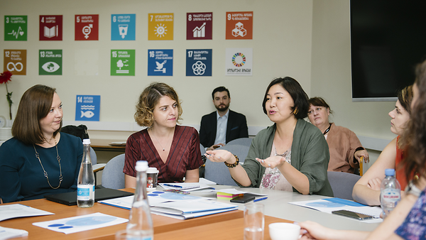 Mehrere Diskussionsteilnehmer auf am Tisch bei einem Workshop zu den Nachhaltigen Entwicklungszielen